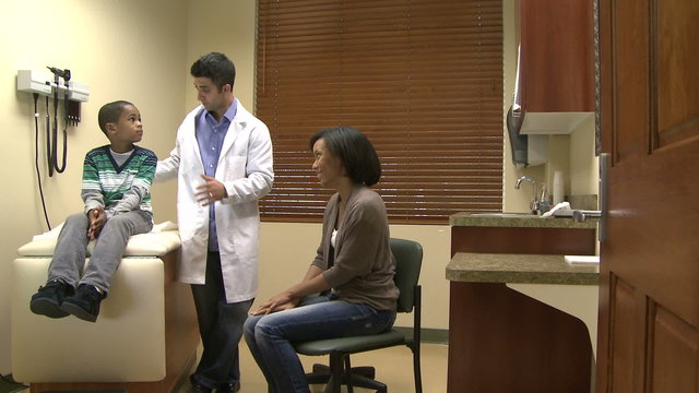Doctor talks with mom and son