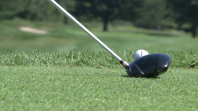 Close-up of driver connecting with golf ball