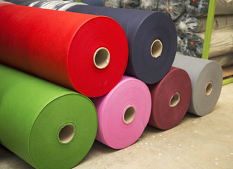 Colorful material fabric rolls in warehouse