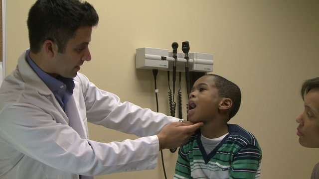 Doctor examines sick child