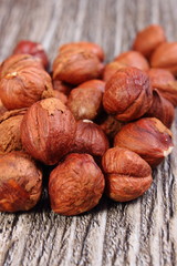 Heap of brown hazelnut on wooden table