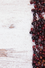 Autumn fresh elderberry and copy space for text on old wooden background