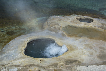 Twin hot springs, one bubbling and steaming, Yellowstone Nationa