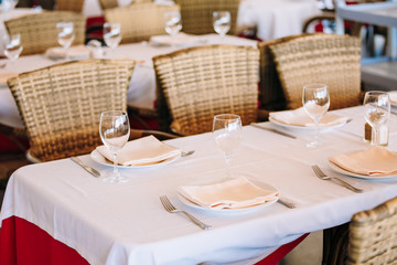 The interior of summer cafe - sheltered tables with white tablec