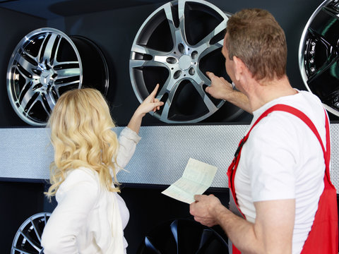 Customer in a showroom of alloy wheels 