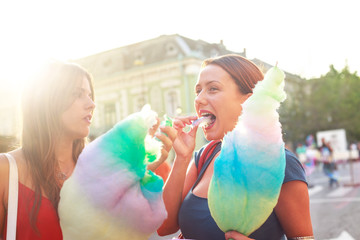 young women eating cotton candy and enjoying