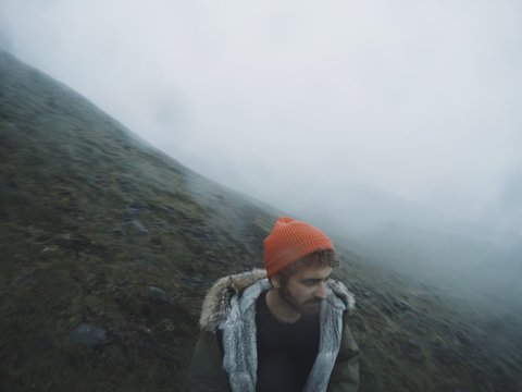 man is hiking in thick fog 