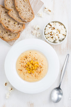 delicious corn soup and bread, top view, vertical
