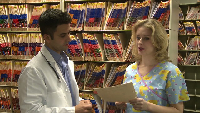 Doctor and Nurse discuss patient's chart