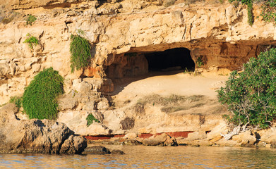 Desert cave in the rock on the beach.