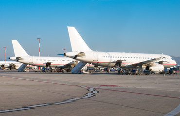 Fototapeta na wymiar Passenger planes in the airport. Aircraft maintenance.