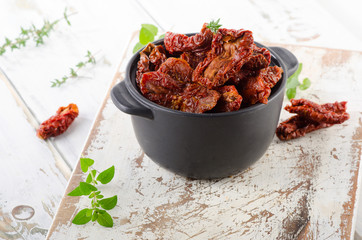 Italian sun dried tomatoes on a wooden table.