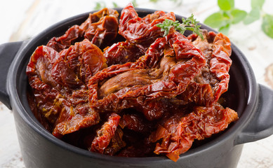Italian sun dried tomatoes on wooden board.