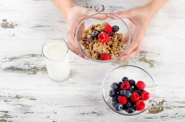 Glass of Yogurt with berries, cereals and muesli.