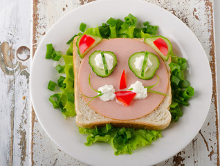 Breakfast with a smiling toast and vegetables.
