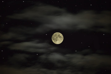 Night sky. Full moon on the starry sky with clouds
