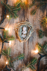 Baby Jesus figurine on a hay decorated with lights and pine twig
