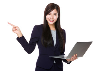 Businesswoman use of the notebook computer and finger pointing a
