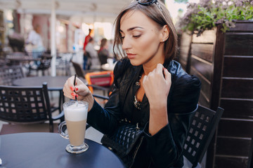 beautiful girl drinking a cappuccino in a cafe