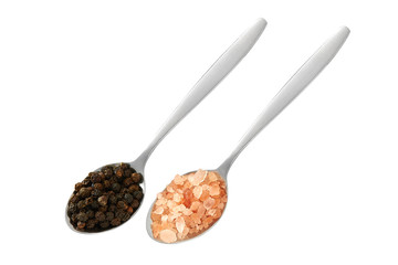 Teaspoons with black pepper and himalayan salt