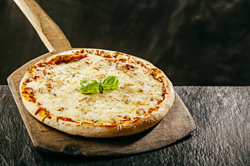 Tasty Italian margarita pizza served in a pizzeria