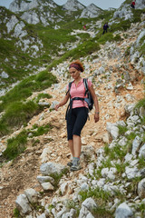 Naklejka na ściany i meble Woman hiker on a steep trail