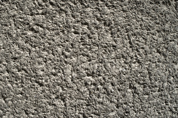 Black old  plaster imitating stone wall