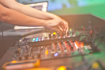DJ mixing music on console