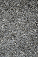 Black old  plaster with small stones wall