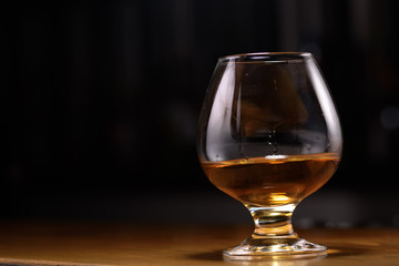 Still life of cognac glass on the bar