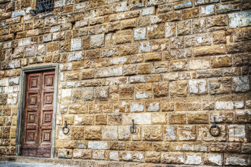 wooden door in a brick wall in hdr