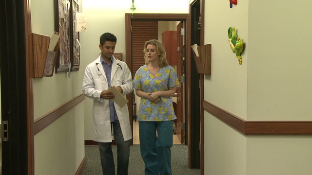 Doctor and nurse have hallway discussion