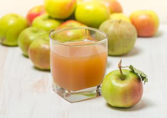 Glass of apple juice and green apples