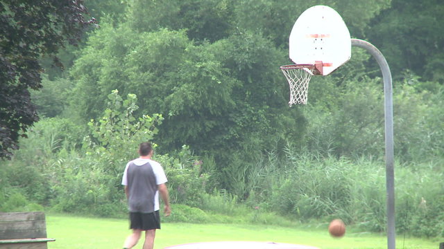 Shooting basketball at a park.
