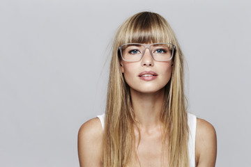 Blue eyed blond student in glasses, portrait