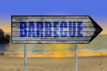 Barbecue wooden sign with a beach on background
