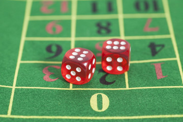 roll of the red dice on a game table in a casino