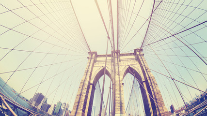 Retro stylized photo of Brooklyn Bridge, fisheye lens, NYC, USA.