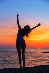 Fototapeta premium Beautiful young woman on the beach at sunset