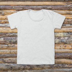 White blank t-shirt on dark wood desk