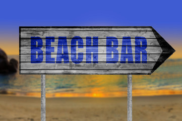Beach Bar wooden sign with on a beach background