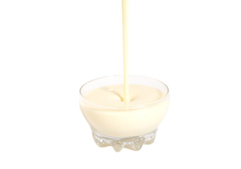 Pouring condensed milk with sugar in glass bowl