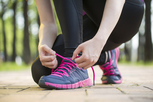 Asian young woman runner tying shoelaces healthy lifestyle © PR Image Factory