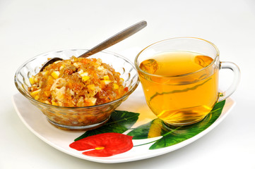 tea and jam-dried fruits, nuts with honey on plate
