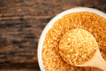 Brown sugar close-up on wooden spoon