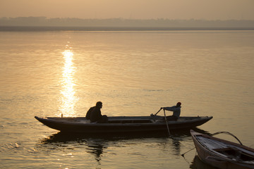 Boat sailing the river at sunset