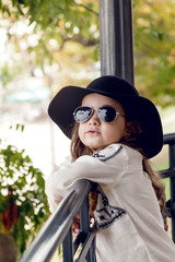 Beautiful little girl with hand and sunglasses