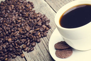 Coffee with beans and cookies on a natural background