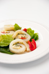 Squid roll with cheese and vegetables on the white background vertical