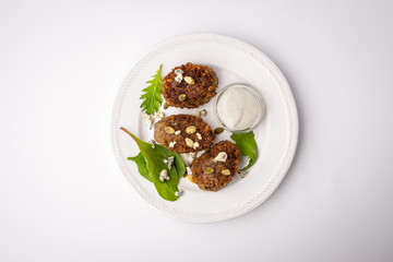 Meat rissoles with pumpkin seeds and sauce dorblu